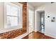 Bright hallway with hardwood floors, white trim, and natural light from the window at 643 Fort Wayne Ave # H, Indianapolis, IN 46204