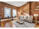 Cozy living room featuring exposed brick, natural light, and stylish decor at 643 Fort Wayne Ave # H, Indianapolis, IN 46204