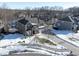 Two-story brick home situated on a tree-lined street with a snow-covered yard at 6711 Colville Pl, Indianapolis, IN 46236