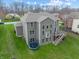 Spacious backyard features a wooden deck, grassy lawn, and trampoline at 6711 Colville Pl, Indianapolis, IN 46236