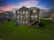 Expansive backyard featuring a wooden deck with stairs and lush green lawn at 6711 Colville Pl, Indianapolis, IN 46236