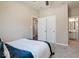Comfortable bedroom with double doors and carpeting at 6711 Colville Pl, Indianapolis, IN 46236