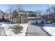 Two-story brick home with a three-car garage and snow-covered landscaping at 6711 Colville Pl, Indianapolis, IN 46236