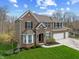 Attractive two-story brick home with an attached two-car garage and landscaped front yard at 6711 Colville Pl, Indianapolis, IN 46236