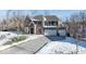 Two-story brick home with a three-car garage and snow-covered landscaping at 6711 Colville Pl, Indianapolis, IN 46236