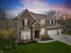 Beautiful two-story brick home with well-manicured lawn and attached two car garage at 6711 Colville Pl, Indianapolis, IN 46236