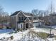 Two-story brick home with a snow covered front yard at 6711 Colville Pl, Indianapolis, IN 46236
