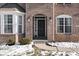 Home's entrance with a black door and brick facade at 6711 Colville Pl, Indianapolis, IN 46236