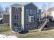 Rear view of house featuring deck, stairs, and trampoline at 6711 Colville Pl, Indianapolis, IN 46236