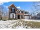 Two-story brick house with attached garage and snowy lawn at 6711 Colville Pl, Indianapolis, IN 46236