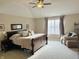 Bright main bedroom featuring a king-size bed and sitting area at 6711 Colville Pl, Indianapolis, IN 46236