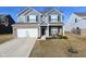 Two-story house with gray siding, brick accents, and a two-car garage at 6802 Aster Dr, Pendleton, IN 46064