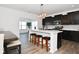 Modern kitchen with dark cabinets and marble island at 6802 Aster Dr, Pendleton, IN 46064