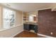 Basement bar area with a brick feature wall and dark cabinets at 8096 Cardinal Cove E, Indianapolis, IN 46256