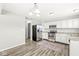 Modern kitchen with stainless steel appliances and hardwood floors at 8103 Grove Berry Way, Indianapolis, IN 46239