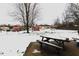 Large backyard with snow, picnic table and sheds at 8257 E 12Th St, Indianapolis, IN 46219