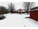 Snowy backyard with a view of the house and sheds at 8257 E 12Th St, Indianapolis, IN 46219