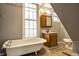 Bathroom with a clawfoot tub, wood vanity, and toilet at 857 S Tompkins St, Shelbyville, IN 46176