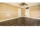 Empty bedroom with hardwood floors, ceiling fan, and window with curtains at 857 S Tompkins St, Shelbyville, IN 46176