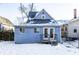 Rear view of the house with a deck and snowy yard at 857 S Tompkins St, Shelbyville, IN 46176