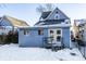 Rear view of the house with a deck and snowy yard at 857 S Tompkins St, Shelbyville, IN 46176