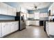 Bright kitchen with white cabinets, stainless steel appliances, and tile flooring at 857 S Tompkins St, Shelbyville, IN 46176