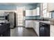 Kitchen features white cabinets, granite countertops, stainless steel appliances, and tile flooring at 857 S Tompkins St, Shelbyville, IN 46176