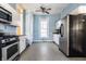 View of kitchen with white cabinets, stainless steel appliances, and tile floor at 857 S Tompkins St, Shelbyville, IN 46176