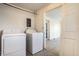 Laundry room with washer, dryer, and access to additional rooms at 857 S Tompkins St, Shelbyville, IN 46176
