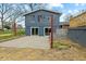 A backyard featuring a concrete patio, a two-story addition, and a wooden deck with stairs at 8810 W Tulip Tree Dr, Muncie, IN 47304