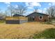 An expansive backyard featuring a deck, mature trees, and a sunroom addition at 8810 W Tulip Tree Dr, Muncie, IN 47304