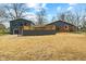 An expansive backyard featuring mature trees, a deck, and a two-story addition at 8810 W Tulip Tree Dr, Muncie, IN 47304