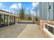 A large deck overlooking the backyard, with an additional patio area next to a sunroom at 8810 W Tulip Tree Dr, Muncie, IN 47304