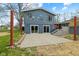 A backyard featuring a concrete patio, a two-story addition, and red metal posts at 8810 W Tulip Tree Dr, Muncie, IN 47304
