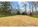 An expansive backyard featuring mature trees, a fenced perimeter, and a shed at 8810 W Tulip Tree Dr, Muncie, IN 47304