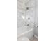 Elegant bathroom with marble tile, a shower, and a new bathtub at 8810 W Tulip Tree Dr, Muncie, IN 47304