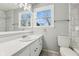 Clean bathroom with single vanity, updated tile, and a large window at 8810 W Tulip Tree Dr, Muncie, IN 47304