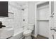 Clean bathroom featuring marble tile shower, a toilet, and linen closet at 8810 W Tulip Tree Dr, Muncie, IN 47304