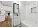 Updated bathroom with marble tile, a new vanity, and a bathtub at 8810 W Tulip Tree Dr, Muncie, IN 47304