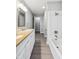 Updated bathroom with double vanity, new flooring, and tub shower combo at 8810 W Tulip Tree Dr, Muncie, IN 47304