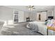 Large main bedroom with grey carpet, a comfortable bed, and access to bathroom at 8810 W Tulip Tree Dr, Muncie, IN 47304