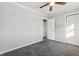 Bedroom with carpet, ceiling fan, and access to hallway at 8810 W Tulip Tree Dr, Muncie, IN 47304