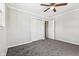 Spacious bedroom with carpet, ceiling fan, and ample closet space at 8810 W Tulip Tree Dr, Muncie, IN 47304