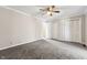 Spacious bedroom with carpet, ceiling fan, and double closets at 8810 W Tulip Tree Dr, Muncie, IN 47304
