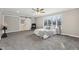Main bedroom with grey carpet, ceiling fan, and sliding barn door at 8810 W Tulip Tree Dr, Muncie, IN 47304