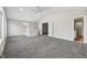 Large bonus room with vaulted ceiling, carpet, and French doors at 8810 W Tulip Tree Dr, Muncie, IN 47304
