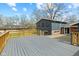 Wide view of a gray wooden deck overlooking a backyard and the side of the home at 8810 W Tulip Tree Dr, Muncie, IN 47304