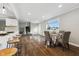 Open concept dining area with hardwood floors and view into living room at 8810 W Tulip Tree Dr, Muncie, IN 47304