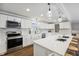 Modern white kitchen with stainless steel appliances and island at 8810 W Tulip Tree Dr, Muncie, IN 47304
