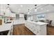 Open concept kitchen boasting white cabinets, quartz countertops, and a breakfast bar at 8810 W Tulip Tree Dr, Muncie, IN 47304